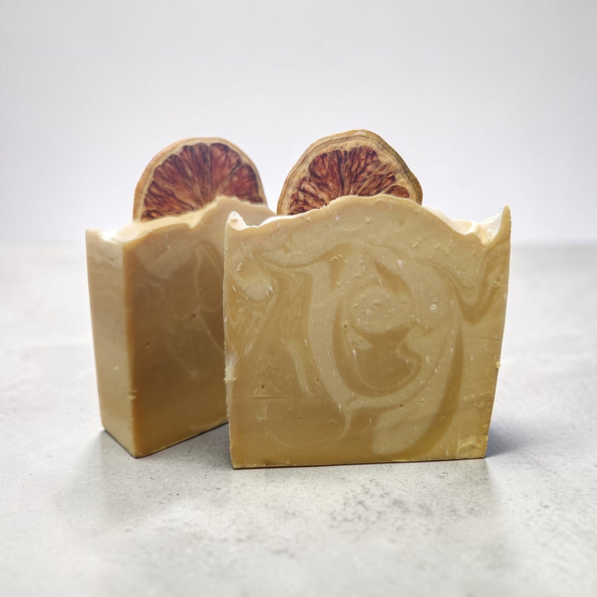 Lemon Drop Glow Bar - two bars on marble surface with dried lemon slice on top