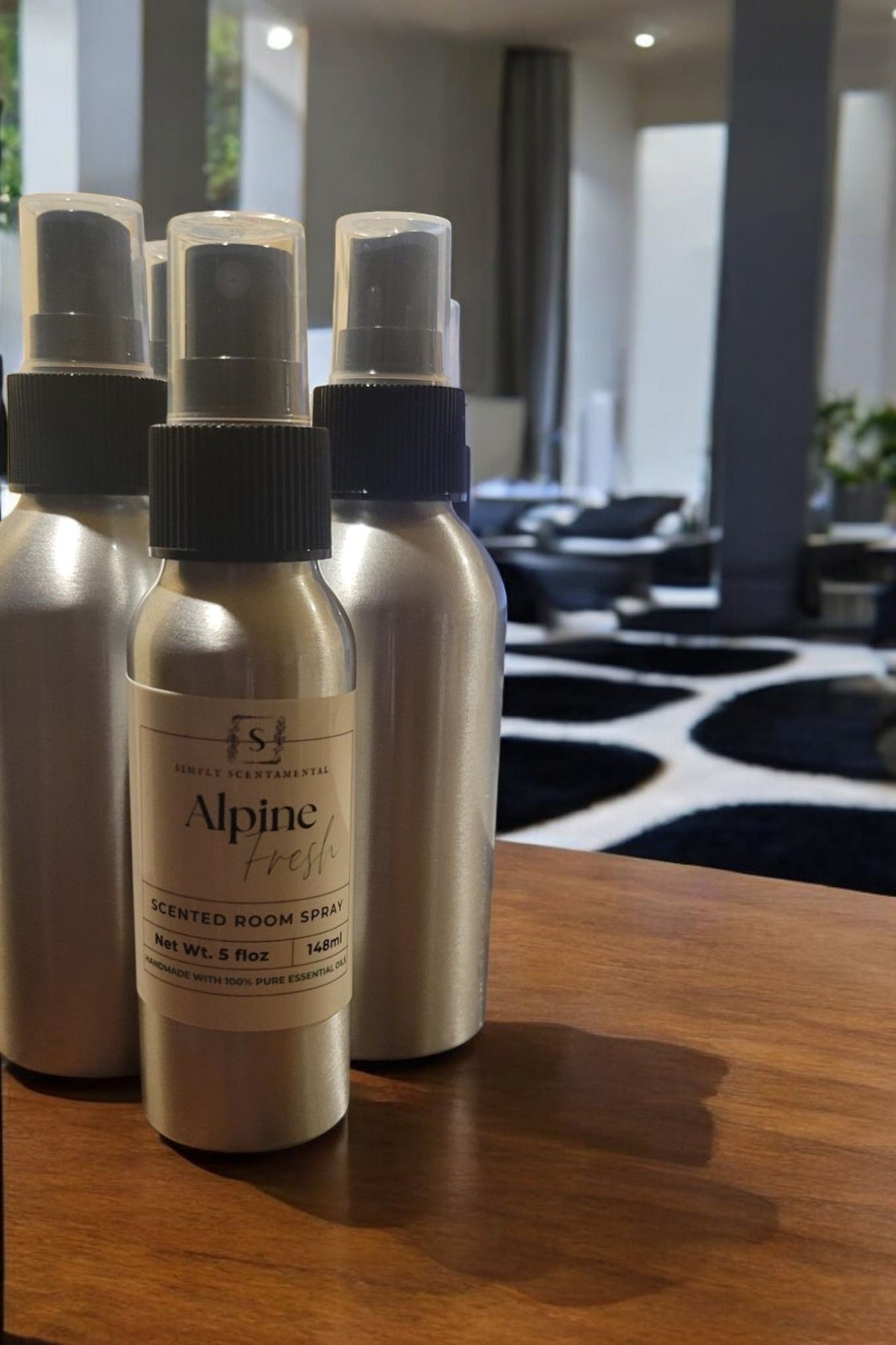 Simply Scentamental Alpine Fresh room and linen spray in silver aluminum bottles on a wooden surface