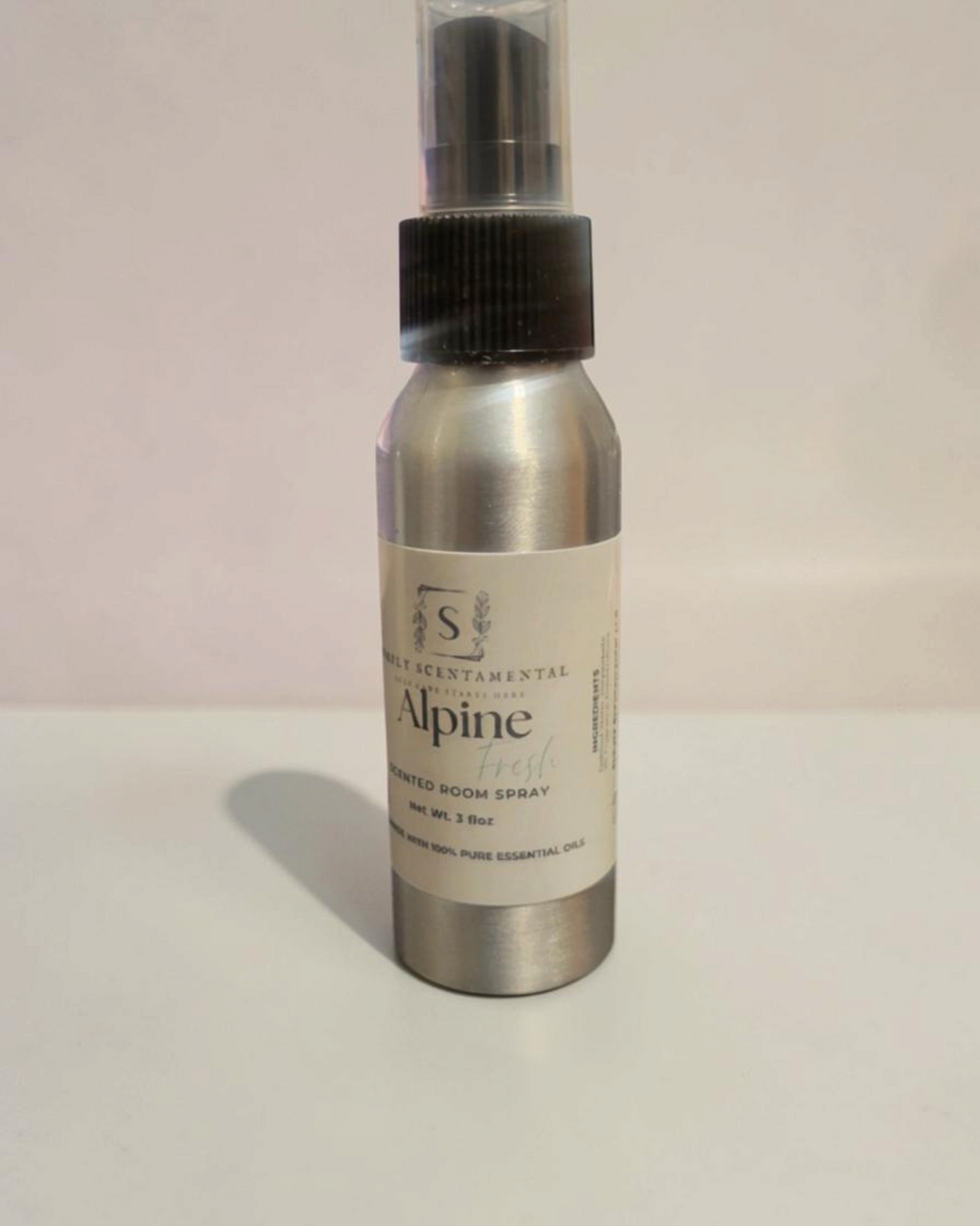 Simply Scentamental Alpine Fresh room and linen spray in a silver metal bottle with a black pump spray nozzle.