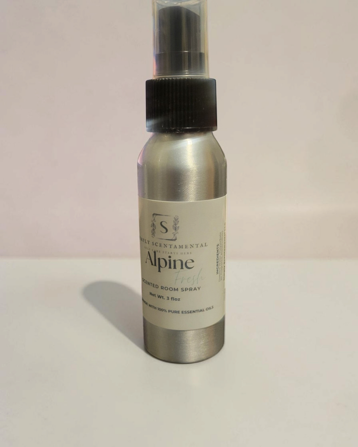 Simply Scentamental Alpine Fresh room and linen spray in a silver aluminum bottle with a black spray nozzle.