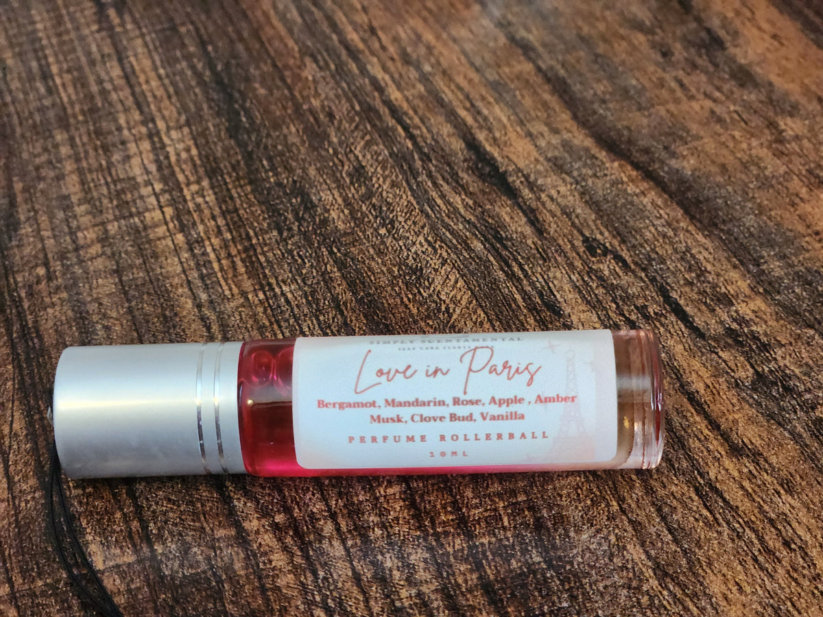 Simply Scentamental Love in Paris 10ml perfume oil rollerball with a floral scent profile on a wooden surface